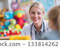 A friendly doctor, a woman communicates with a small patient 133814262