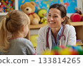 Friendly doctor, a woman communicates with a small patient 133814265