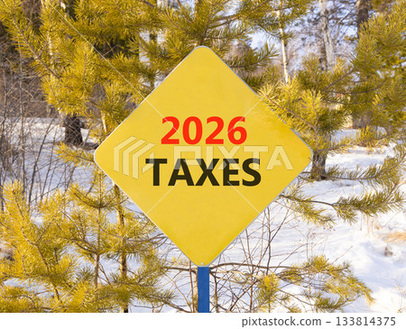 2026 taxes new year symbol. Concept words 2026 taxes on beautiful yellow road sign. Beautiful winter forest background. Business and 2026 taxes new year concept. Copy space. 2026 taxes new year symbol. Concept words 2026 taxes on beautiful yellow road sign. Beautiful winter forest background. Business and 2026 taxes new year concept. Copy space. 133814375