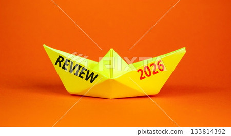 Review 2026 symbol. Concept words Review 2026 on beautiful yellow paper boat. Beautiful orange paper background. Business and review 2026 concept. Copy space. Review 2026 symbol. Concept words Review 2026 on beautiful yellow paper boat. Beautiful orange paper background. Business and review 2026 concept. Copy space. 133814392