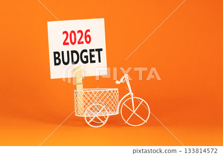 2026 Budget symbol. Concept words 2026 Budget on beautiful white paper on wooden clothespin. Beautiful orange background. Beautiful miniature bicycle. Business and 2026 budget concept. Copy space. 2026 Budget symbol. Concept words 2026 Budget on beautiful white paper on wooden clothespin. Beautiful orange background. Beautiful miniature bicycle. Business and 2026 budget concept. Copy space. 133814572