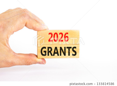 2026 Grants symbol. Concept words 2026 Grants on beautiful wooden blocks. Beautiful white paper background. Businessman's hand. Business and 2026 grants concept. Copy space. 2026 Grants symbol. Concept words 2026 Grants on beautiful wooden blocks. Beautiful white paper background. Businessman's hand. Business and 2026 grants concept. Copy space. 133814586
