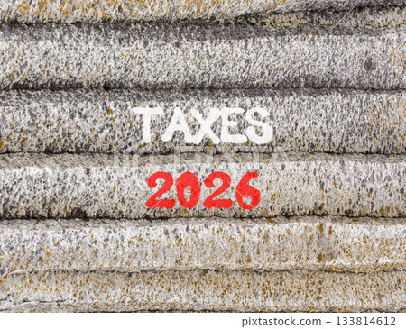 Taxes 2026 new year symbol. Concept words Taxes 2026 on beautiful grey mountain wall. Beautiful grey mountain wall background. Business and taxes 2026 new year concept. Copy space. Taxes 2026 new year symbol. Concept words Taxes 2026 on beautiful grey mountain wall. Beautiful grey mountain wall background. Business and taxes 2026 new year concept. Copy space. 133814612