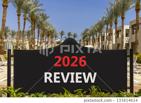 2026 Review symbol. Concept words 2026 Review on beautiful black road sign. Beautiful palm trees palm-trees and blue sky background. Business and 2026 review concept. Copy space. 133814614