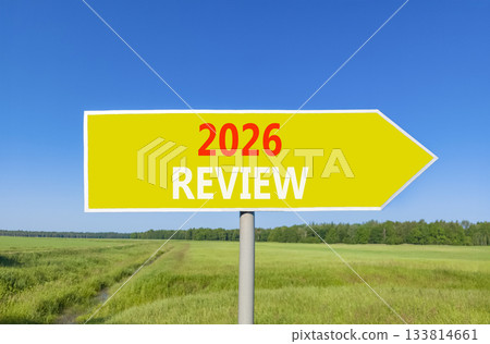 2026 Review symbol. Concept words 2026 Review on beautiful yellow road sign. Beautiful green grass field forest and blue sky background. Business and 2026 review concept. Copy space. 133814661