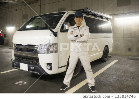 Worker standing next to a car 133814746