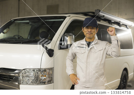 Worker standing next to a car 133814758
