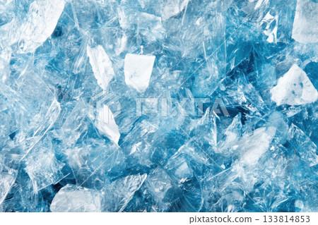 Shards of clear and blue ice are scattered, reflecting light and forming an intriguing texture and color mix Shards of clear and blue ice are scattered, reflecting light and forming an intriguing texture and color mix 133814853