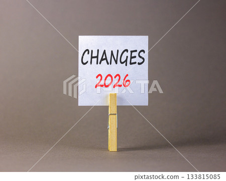 Changes 2026 symbol. Concept words Changes 2026 on beautiful white paper on wooden clothespin. Beautiful grey background. Business and changes 2026 concept. Copy space. 133815085