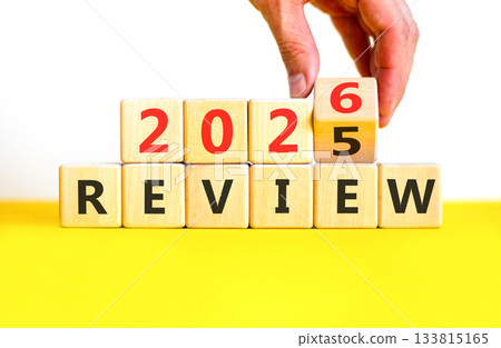 2026 Review symbol. Concept words 2026 Review on beautiful wooden blocks. Beautiful white and yellow paper background. Businessman's hand. Business and 2026 review concept. Copy space. 133815165