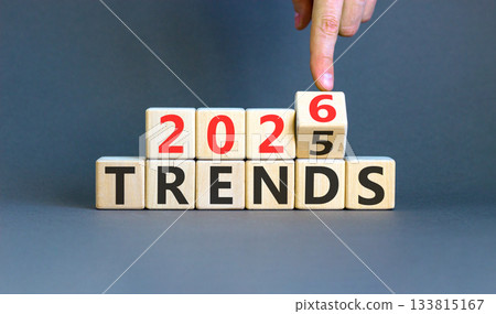2026 Trends new year symbol. Concept words 2026 Trends on beautiful wooden blocks. Beautiful grey paper background. Businessman's hand. Business and 2026 Trends new year concept. Copy space. 133815167
