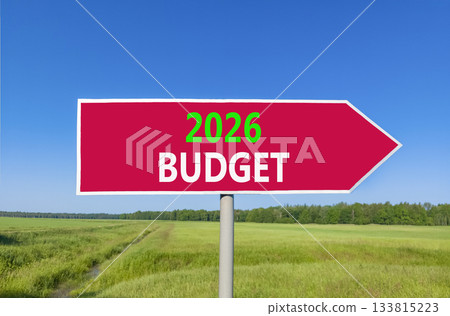 2026 Budget symbol. Concept words 2026 Budget on beautiful red road sign. Beautiful green grass field forest and blue sky background. Business and 2026 budget concept. Copy space. 2026 Budget symbol. Concept words 2026 Budget on beautiful red road sign. Beautiful green grass field forest and blue sky background. Business and 2026 budget concept. Copy space. 133815223