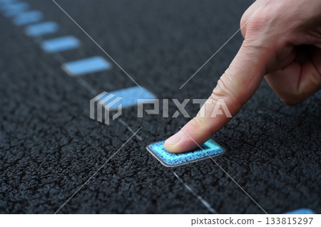 hand presses on the parking button hand presses on the parking button 133815297