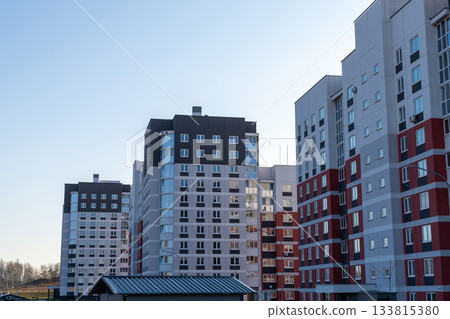 Modern high-rise apartment buildings featuring gray, white, and red facades Modern high-rise apartment buildings featuring gray, white, and red facades 133815380