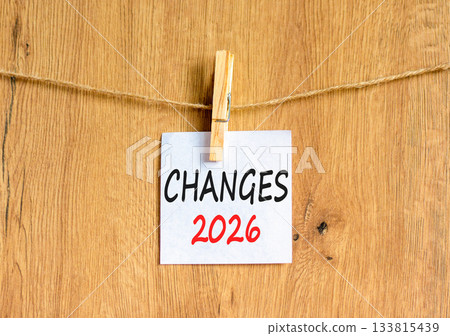 Changes 2026 symbol. Concept words Changes 2026 on beautiful white paper on wooden clothespin. Beautiful wooden background. Business and changes 2026 concept. Copy space. 133815439