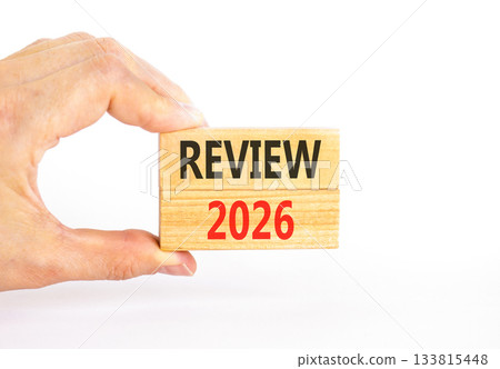 Review 2026 symbol. Concept words Review 2026 on beautiful wooden blocks. Beautiful white paper background. Businessman's hand. Business and review 2026 concept. Copy space. 133815448