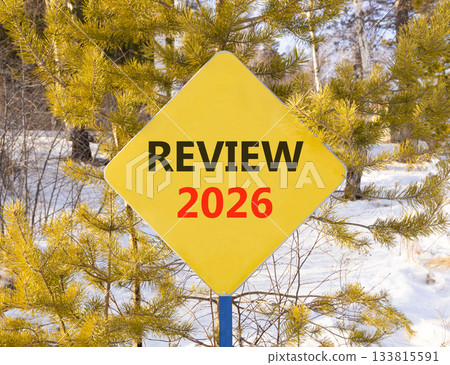 Review 2026 symbol. Concept words Review 2026 on beautiful yellow road sign. Beautiful winter forest background. Business and review 2026 concept. Copy space. Review 2026 symbol. Concept words Review 2026 on beautiful yellow road sign. Beautiful winter forest background. Business and review 2026 concept. Copy space. 133815591