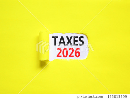 Taxes 2026 new year symbol. Concept words Taxes 2026 on beautiful white paper. Beautiful yellow paper background. Business and taxes 2026 new year concept. Copy space. 133815599