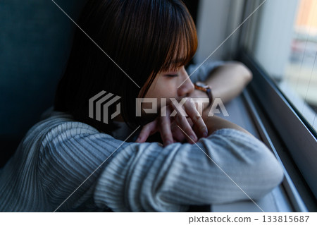 Young woman napping by the window 133815687