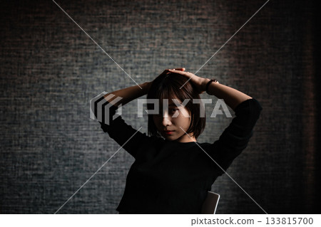 Young woman posing in a dark room Young woman posing in a dark room 133815700