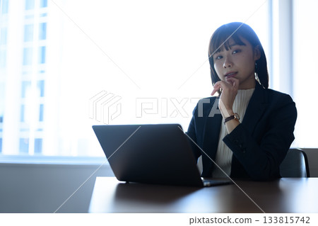 A young female business person working at a desk with a laptop 133815742
