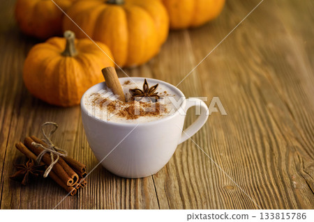 Autumn Pumpkin Spice Latte. A warm spiced latte with cinnamon and star anise, surrounded by pumpkins Autumn Pumpkin Spice Latte. A warm spiced latte with cinnamon and star anise, surrounded by pumpkins 133815786