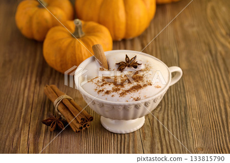 Autumn Pumpkin Spice Latte. A warm spiced latte with cinnamon and star anise, surrounded by pumpkins 133815790