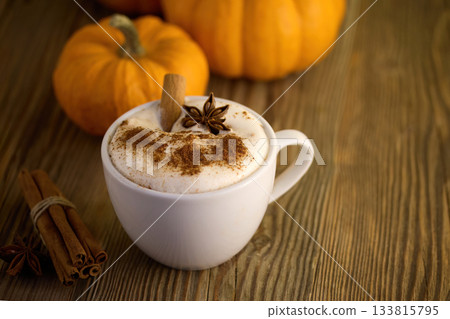 Autumn Pumpkin Spice Latte. A warm latte with cinnamon and star anise, surrounded by pumpkins 133815795