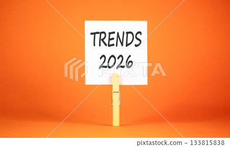 Trends 2026 new year symbol. Concept words Trends 2026 on beautiful white paper on wooden clothespin. Beautiful orange background. Business and Trends 2026 new year concept. Copy space. Trends 2026 new year symbol. Concept words Trends 2026 on beautiful white paper on wooden clothespin. Beautiful orange background. Business and Trends 2026 new year concept. Copy space. 133815838
