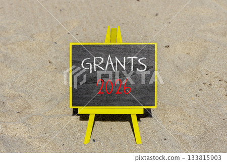 Grants 2026 symbol. Concept words Grants 2026 on beautiful black blackboard. Beautiful sand beach background. Business and grants 2026 concept. Copy space. Grants 2026 symbol. Concept words Grants 2026 on beautiful black blackboard. Beautiful sand beach background. Business and grants 2026 concept. Copy space. 133815903