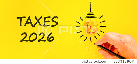 Taxes 2026 new year symbol. Concept words Taxes 2026 on beautiful yellow paper. Beautiful orange paper background. Businessman's hand with pen. Business and taxes 2026 new year concept. Copy space. Taxes 2026 new year symbol. Concept words Taxes 2026 on beautiful yellow paper. Beautiful orange paper background. Businessman's hand with pen. Business and taxes 2026 new year concept. Copy space. 133815907