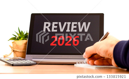 Review 2026 symbol. Concept words Review 2026 on beautiful black tablet screen. Beautiful white background. Businessman's hand. Business and review 2026 concept. Copy space. Review 2026 symbol. Concept words Review 2026 on beautiful black tablet screen. Beautiful white background. Businessman's hand. Business and review 2026 concept. Copy space. 133815921