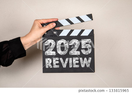 2025 Review. Film Clapperboard Held Against a Neutral Background 133815965