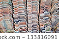 Rhythmic Wavy Pattern of Stacked Terracotta Roof Tiles 133816091