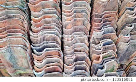 Rhythmic Wavy Pattern of Stacked Terracotta Roof Tiles 133816091