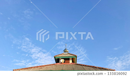 Mosque Roof and Crescent Spire Against Blue Sky and Moon Mosque Roof and Crescent Spire Against Blue Sky and Moon 133816092