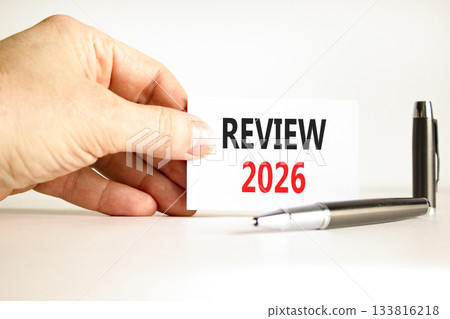 Review 2026 symbol. Concept words Review 2026 on beautiful white card. Beautiful white paper background. Businessman's hand. Business and review 2026 concept. Copy space. Review 2026 symbol. Concept words Review 2026 on beautiful white card. Beautiful white paper background. Businessman's hand. Business and review 2026 concept. Copy space. 133816218