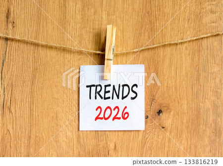 Trends 2026 new year symbol. Concept words Trends 2026 on beautiful white paper on wooden clothespin. Beautiful wooden background. Business and Trends 2026 new year concept. Copy space. 133816219