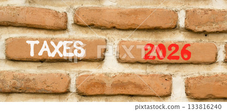 Taxes 2026 new year symbol. Concept words Taxes 2026 on beautiful brown brick wall. Beautiful brown brick wall background. Business and taxes 2026 new year concept. Copy space. Taxes 2026 new year symbol. Concept words Taxes 2026 on beautiful brown brick wall. Beautiful brown brick wall background. Business and taxes 2026 new year concept. Copy space. 133816240