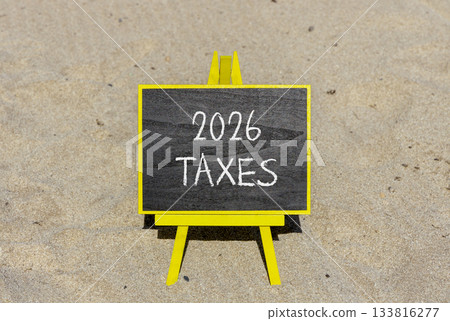 2026 taxes new year symbol. Concept words 2026 taxes on beautiful black blackboard. Beautiful sand beach background. Business and 2026 taxes new year concept. Copy space. 133816277