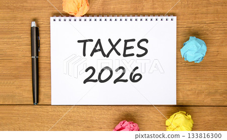 Taxes 2026 new year symbol. Concept words Taxes 2026 on beautiful white note. Beautiful wooden background. Black pen. Colored paper. Business and taxes 2026 new year concept. Copy space. Taxes 2026 new year symbol. Concept words Taxes 2026 on beautiful white note. Beautiful wooden background. Black pen. Colored paper. Business and taxes 2026 new year concept. Copy space. 133816300