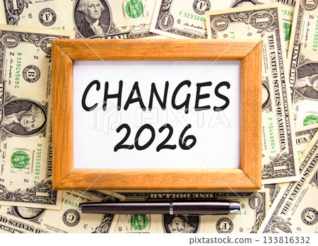 Changes 2026 symbol. Concept words Changes 2026 on beautiful wooden picture frame. Beautiful dollar bills background. Black pen. Dollar bills. Business and changes 2026 concept. Copy space. 133816332