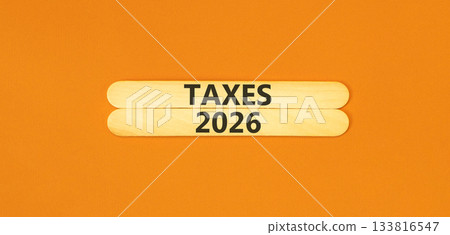 Taxes 2026 new year symbol. Concept words Taxes 2026 on beautiful wooden sticks. Beautiful orange paper background. Business and taxes 2026 new year concept. Copy space. Taxes 2026 new year symbol. Concept words Taxes 2026 on beautiful wooden sticks. Beautiful orange paper background. Business and taxes 2026 new year concept. Copy space. 133816547