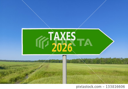 Taxes 2026 new year symbol. Concept words Taxes 2026 on beautiful green road sign. Beautiful green grass field forest and blue sky background. Business and taxes 2026 new year concept. Copy space. Taxes 2026 new year symbol. Concept words Taxes 2026 on beautiful green road sign. Beautiful green grass field forest and blue sky background. Business and taxes 2026 new year concept. Copy space. 133816606