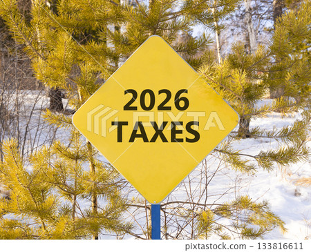 2026 taxes new year symbol. Concept words 2026 taxes on beautiful yellow road sign. Beautiful winter forest background. Business and 2026 taxes new year concept. Copy space. 2026 taxes new year symbol. Concept words 2026 taxes on beautiful yellow road sign. Beautiful winter forest background. Business and 2026 taxes new year concept. Copy space. 133816611