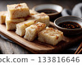 Slices of steamed turnip cake on a wooden board, soy dipping sauce nearby, simple Cantonese New Year atmosphere 133816646