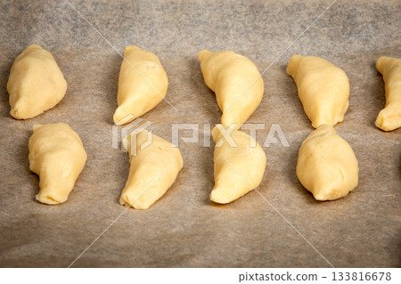Unbaked Homemade Pastries Arranged on Parchment Paper Before Baking Unbaked Homemade Pastries Arranged on Parchment Paper Before Baking 133816678