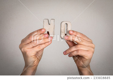 Hands Holding Concrete Letter Blocks Forming the Word No Hands Holding Concrete Letter Blocks Forming the Word No 133816685