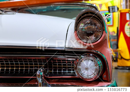 Classic vintage car with shiny details displayed at retro automotive exhibition indoors Classic vintage car with shiny details displayed at retro automotive exhibition indoors 133816773