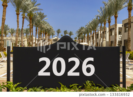 Business concept of 2026 new year symbol. Concept number 2026 Happy new year on beautiful black road sign. Beautiful palm trees palm-tree background. Business 2026 happy new year concept. Copy space. 133816932